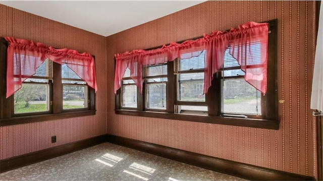 41 E Euclid Ave, Barron, WI 54812 - empty room with plenty of natural light, wallpapered walls, and baseboards