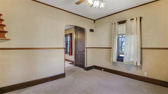 41 E Euclid Ave, Barron, WI 54812 - carpeted spare room with arched walkways, ornamental molding, ceiling fan, and baseboards