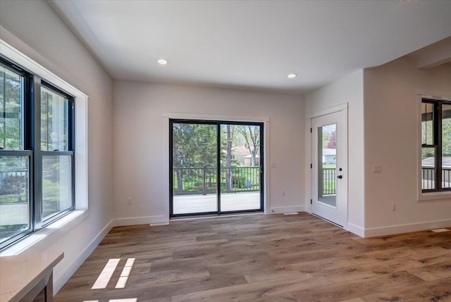 713 Kennedy St, Sauk City, WI 53583 - unfurnished room with plenty of natural light, light wood-type flooring, baseboards, and recessed lighting