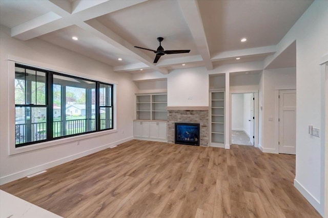 713 Kennedy St, Sauk City, WI 53583 - unfurnished living room with light wood finished floors, baseboards, beam ceiling, recessed lighting, and coffered ceiling