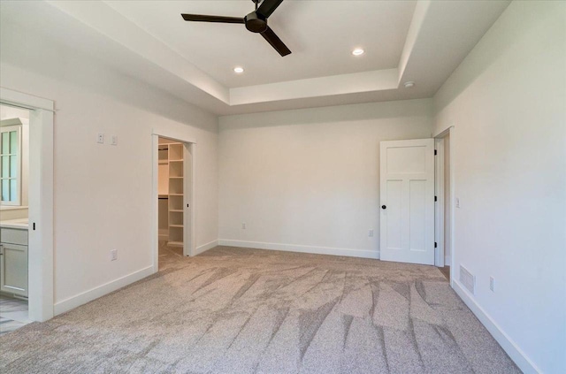 713 Kennedy St, Sauk City, WI 53583 - spare room featuring a ceiling fan, light carpet, recessed lighting, a raised ceiling, and baseboards