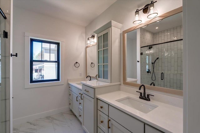 713 Kennedy St, Sauk City, WI 53583 - bathroom with a shower stall, marble finish floors, baseboards, and two vanities