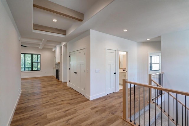 713 Kennedy St, Sauk City, WI 53583 - hallway with an upstairs landing, light wood-type flooring, beam ceiling, baseboards, and recessed lighting