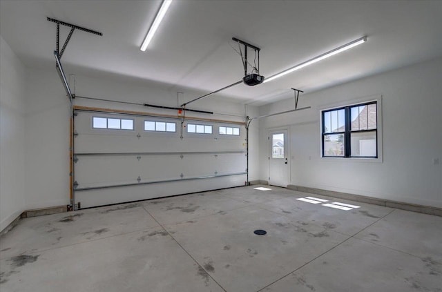 713 Kennedy St, Sauk City, WI 53583 - garage featuring a garage door opener and baseboards