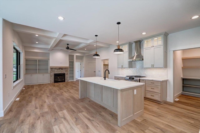 713 Kennedy St, Sauk City, WI 53583 - kitchen with wall chimney exhaust hood, a ceiling fan, stainless steel gas stove, light wood finished floors, and recessed lighting