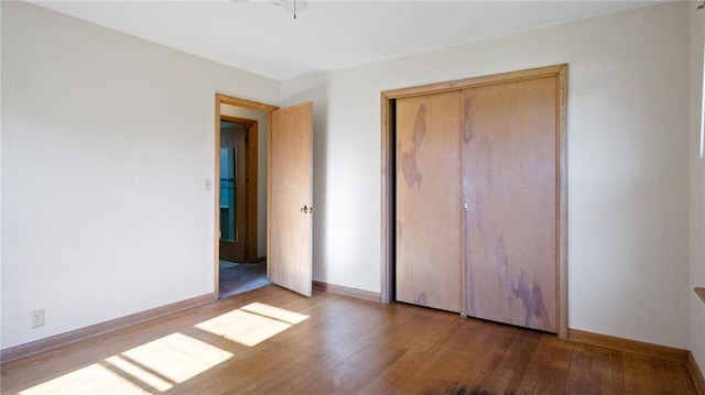1408 E Lexington Blvd, Eau Claire, WI 54701 - unfurnished bedroom featuring wood finished floors, a closet, and baseboards