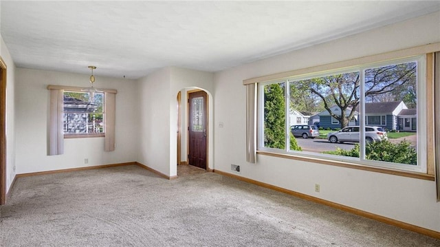 1408 E Lexington Blvd, Eau Claire, WI 54701 - spare room featuring plenty of natural light, arched walkways, carpet flooring, and baseboards