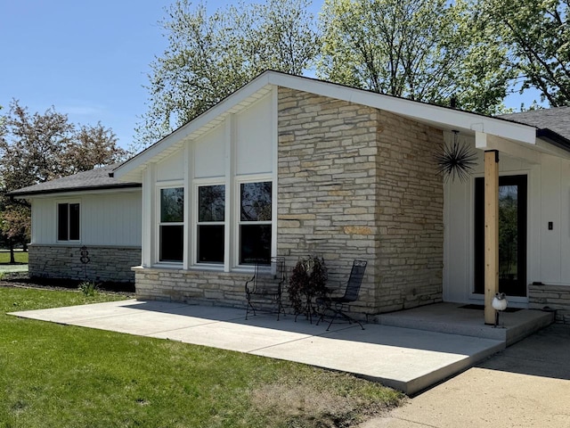 1421 N Golden Lake Rd, Summit, WI 53066 - back of house with stone siding, a lawn, and a shingled roof