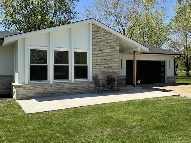 1421 N Golden Lake Rd, Summit, WI 53066 - view of side of home with stone siding, an attached garage, concrete driveway, and board and batten siding