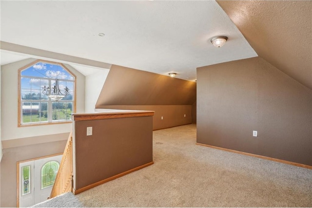 2136 62nd St, Somerset, WI 54025 - bonus room with lofted ceiling, carpet, baseboards, and a textured ceiling