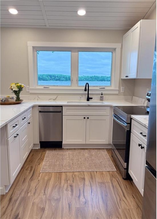 11445 State Highway 48, Luck, WI 54853 - kitchen featuring appliances with stainless steel finishes, a sink, white cabinets, healthy amount of natural light, and recessed lighting