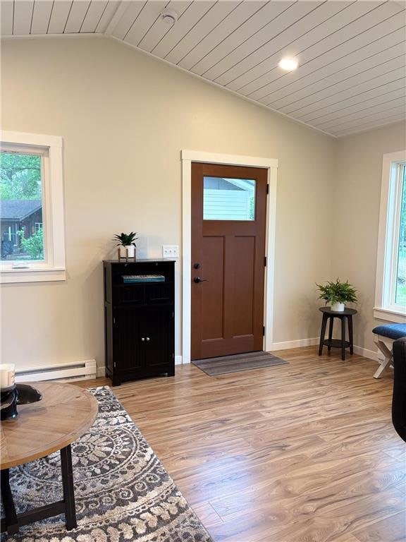 11445 State Highway 48, Luck, WI 54853 - entryway featuring lofted ceiling, light wood-style flooring, wood ceiling, a baseboard radiator, and baseboards