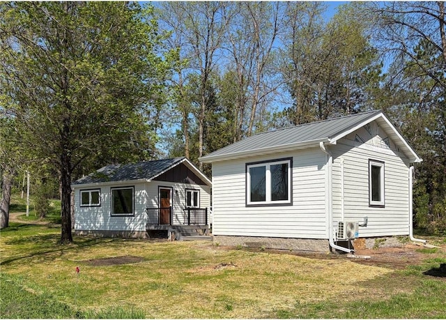 11445 State Highway 48, Luck, WI 54853 - view of front of house with a front yard, a cooling unit, metal roof, and a standing seam roof