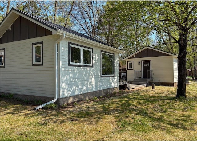 11445 State Highway 48, Luck, WI 54853 - view of side of property featuring board and batten siding and a lawn