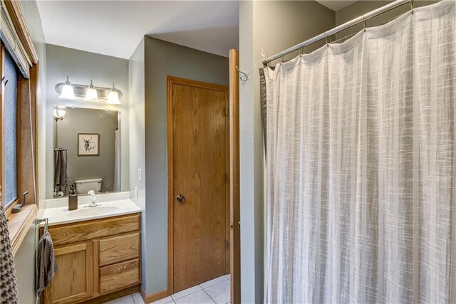 1813 Abbe Hill Dr, Eau Claire, WI 54703 - bathroom featuring tile patterned floors, vanity, toilet, and a shower with shower curtain