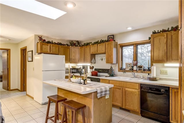 1813 Abbe Hill Dr, Eau Claire, WI 54703 - kitchen with black dishwasher, a sink, freestanding refrigerator, light tile patterned floors, and a center island