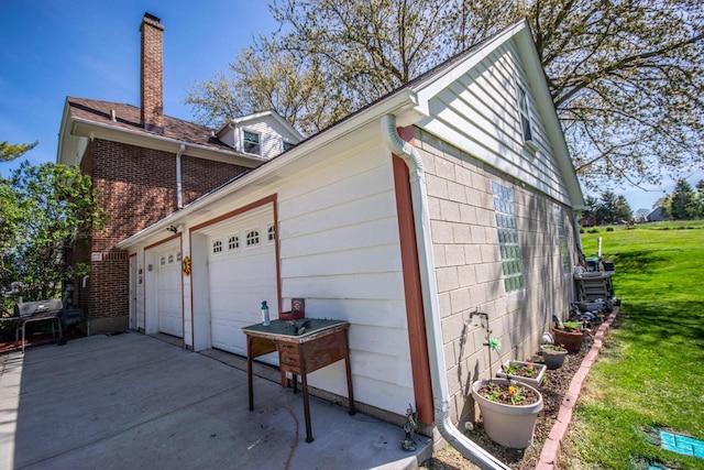 5291 Deer Rd, Hartford, WI 53027 - view of side of property featuring a chimney, a lawn, and brick siding