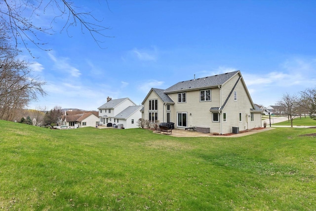 W127S9630 Scott Krause Dr, Muskego, WI 53150 - rear view of house with a patio, a lawn, and central AC unit