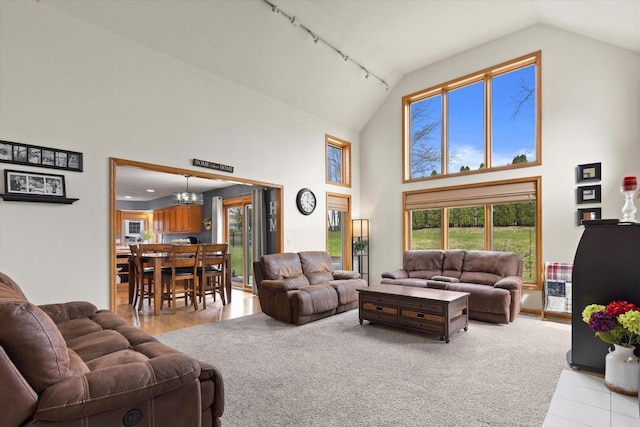 W127S9630 Scott Krause Dr, Muskego, WI 53150 - living room featuring high vaulted ceiling, rail lighting, and a chandelier
