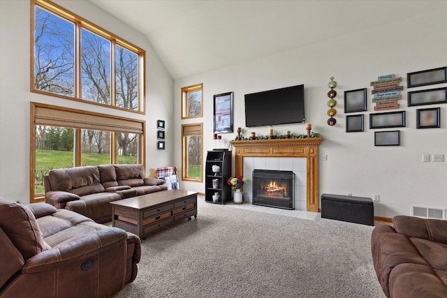 W127S9630 Scott Krause Dr, Muskego, WI 53150 - living room with high vaulted ceiling, carpet floors, and a tiled fireplace
