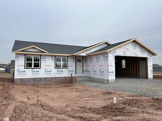 2080 Red Fox Ln, Kaukauna, WI 54130 - unfinished property featuring a garage, gravel driveway, and crawl space