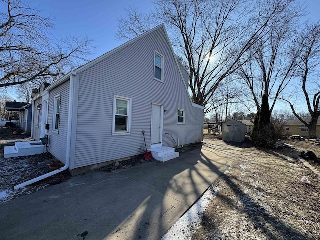 1306 W Wisconsin St, Portage, WI 53901 - back of house featuring a storage shed, an outbuilding, and entry steps