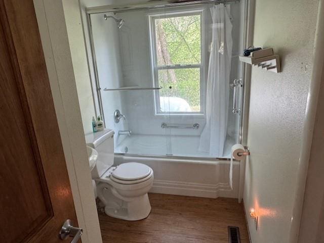 1404 Silver Mine Dr, Eau Claire, WI 54703 - full bath featuring wood finished floors, bath / shower combo with glass door, and toilet