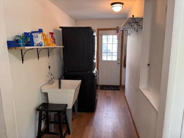 1404 Silver Mine Dr, Eau Claire, WI 54703 - clothes washing area featuring stacked washing machine and dryer and wood finished floors