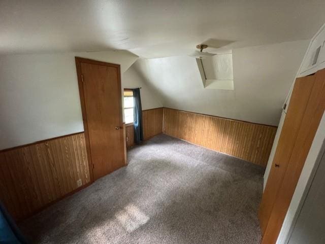 1404 Silver Mine Dr, Eau Claire, WI 54703 - additional living space featuring wood walls, lofted ceiling, carpet flooring, and a wainscoted wall
