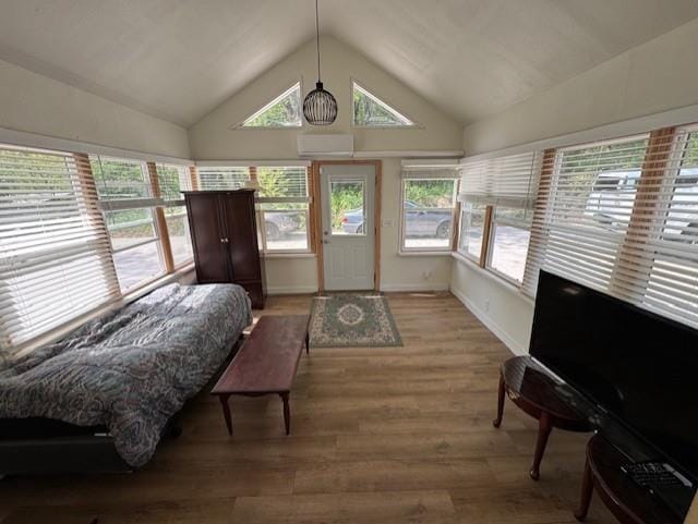 1404 Silver Mine Dr, Eau Claire, WI 54703 - bedroom with a wall unit AC, vaulted ceiling, light wood-style floors, and baseboards