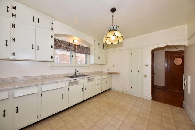 3434 N 45th St, Milwaukee, WI 53216 - kitchen featuring a sink, light countertops, white cabinetry, and hanging light fixtures
