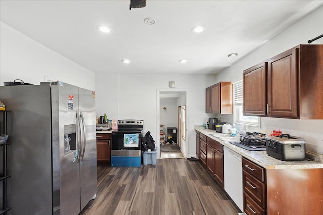 423 Maryhill Dr, Green Bay, WI 54303 - kitchen featuring appliances with stainless steel finishes, light countertops, dark wood finished floors, a sink, and recessed lighting