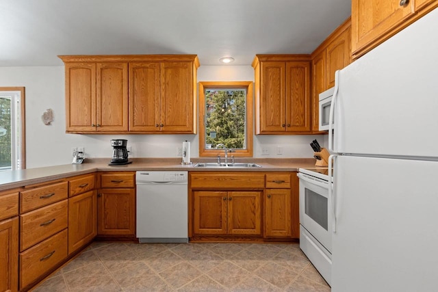 2289 Northwood Rd, Green Bay, WI 54313 - kitchen featuring white appliances, a sink, brown cabinetry, recessed lighting, and light countertops
