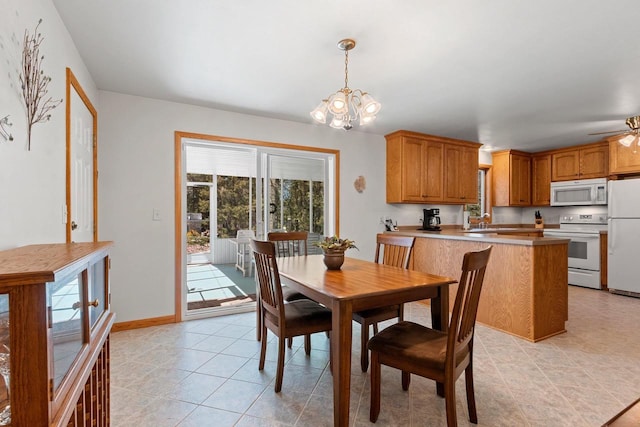 2289 Northwood Rd, Green Bay, WI 54313 - dining space featuring healthy amount of natural light, a chandelier, light tile patterned floors, and baseboards
