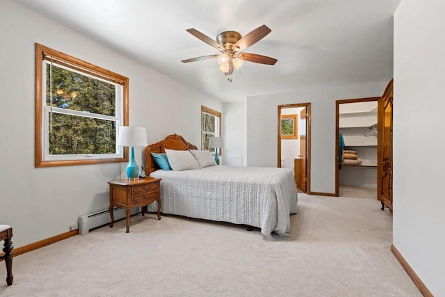 2289 Northwood Rd, Green Bay, WI 54313 - bedroom with light carpet, a walk in closet, baseboards, a baseboard radiator, and ceiling fan