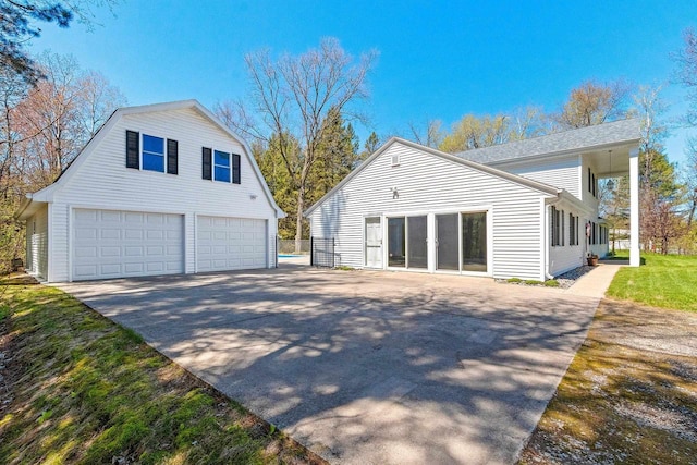 2289 Northwood Rd, Green Bay, WI 54313 - view of home's exterior featuring an outbuilding and concrete driveway