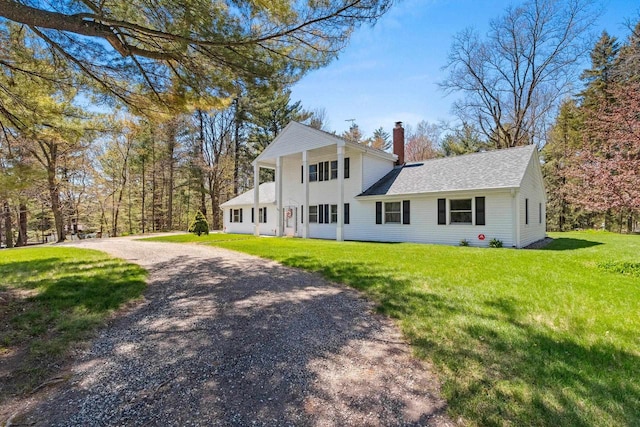 2289 Northwood Rd, Green Bay, WI 54313 - neoclassical home featuring roof with shingles, a chimney, a front lawn, and dirt driveway