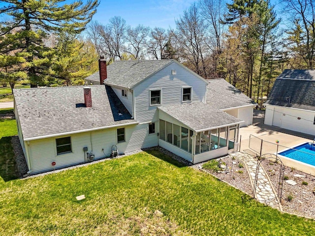 2289 Northwood Rd, Green Bay, WI 54313 - back of house with a sunroom, roof with shingles, and a chimney