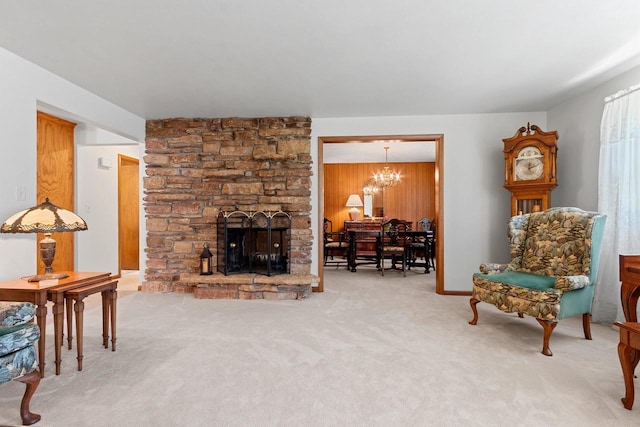 2289 Northwood Rd, Green Bay, WI 54313 - carpeted living area featuring a chandelier, a fireplace, and wooden walls