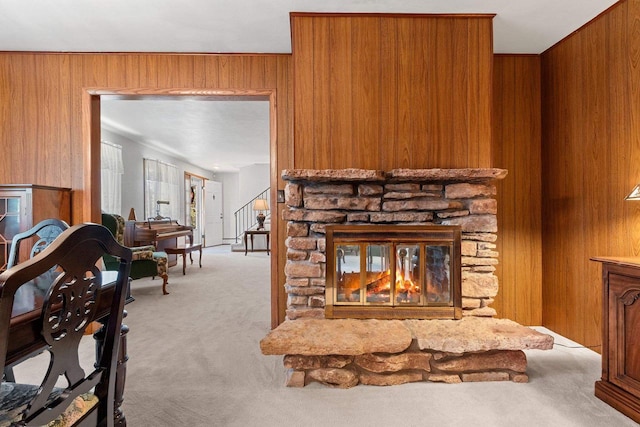 2289 Northwood Rd, Green Bay, WI 54313 - carpeted living room with wood walls, a stone fireplace, and stairs
