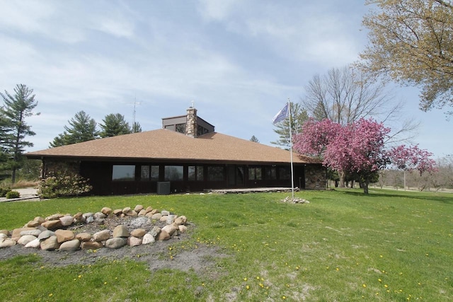 N3177 14th Dr, Montello, WI 53949 - rear view of property with a lawn, central air condition unit, roof with shingles, and a chimney