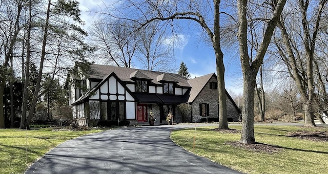 18585 Woodberry Ct, Brookfield, WI 53045 - english style home featuring a front lawn, asphalt driveway, and stone siding