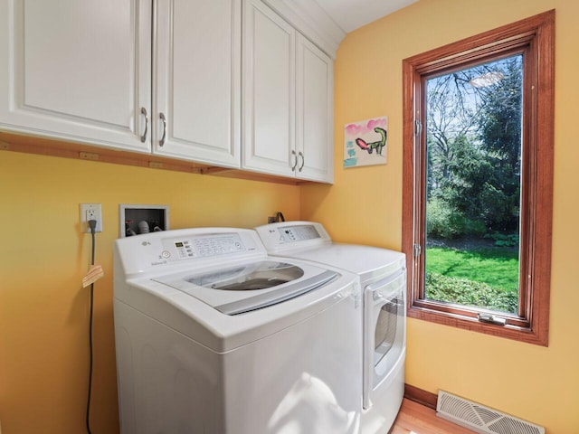 18585 Woodberry Ct, Brookfield, WI 53045 - laundry room featuring cabinet space, washing machine and clothes dryer, and healthy amount of natural light