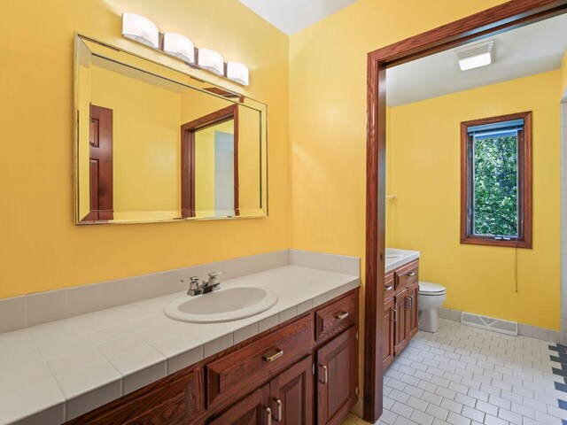 18585 Woodberry Ct, Brookfield, WI 53045 - bathroom featuring vanity, toilet, baseboards, and tile patterned flooring