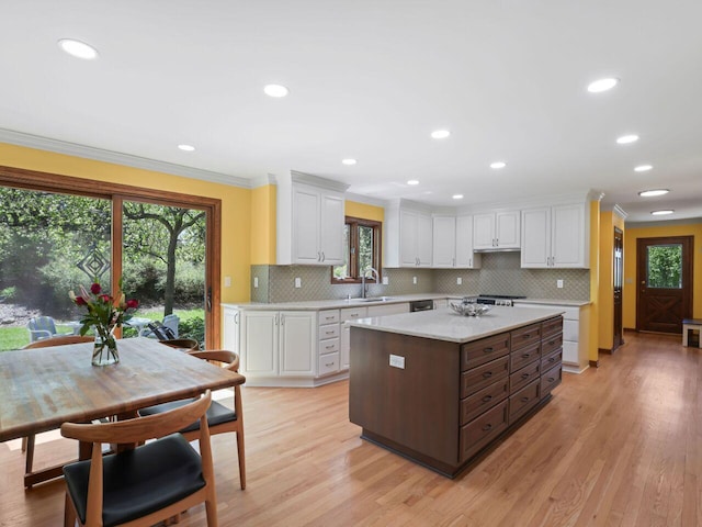 18585 Woodberry Ct, Brookfield, WI 53045 - kitchen featuring healthy amount of natural light, ornamental molding, white cabinetry, backsplash, and light wood-type flooring