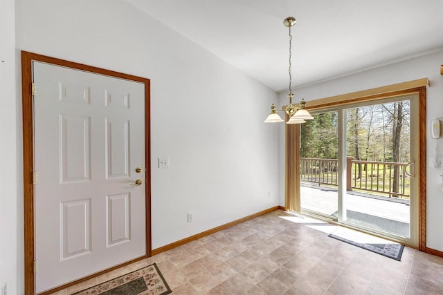 N11598 Helgeson Rd, Iola, WI 54945 - unfurnished dining area with a chandelier and baseboards