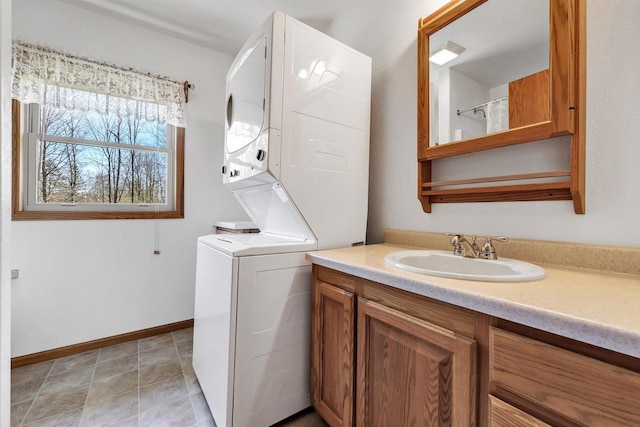 N11598 Helgeson Rd, Iola, WI 54945 - washroom with stacked washer / dryer, a sink, and baseboards