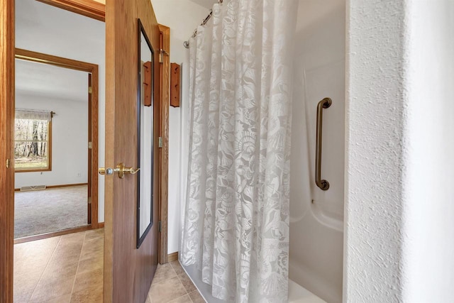 N11598 Helgeson Rd, Iola, WI 54945 - bathroom featuring curtained shower, tile patterned floors, and baseboards