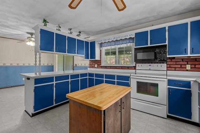 290 S Bridge St, Markesan, WI 53946 - kitchen with black microwave, white range with electric cooktop, ceiling fan, and blue cabinetry