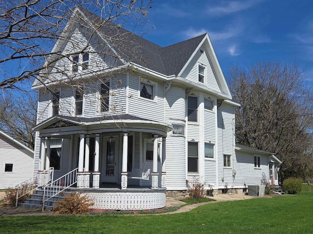 290 S Bridge St, Markesan, WI 53946 - view of front of house with covered porch, a front lawn, and a shingled roof